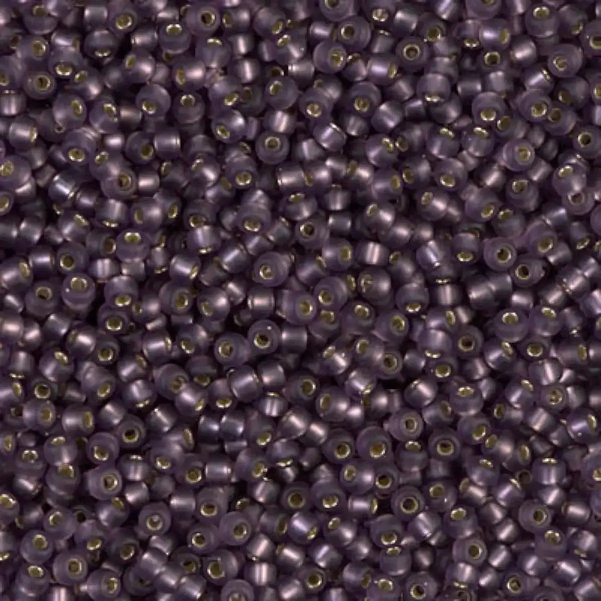 Close-up of small purple , gold-lined glass beads