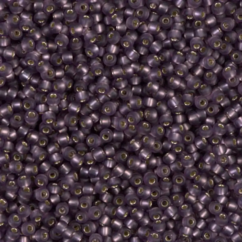 Close-up of small purple , gold-lined glass beads