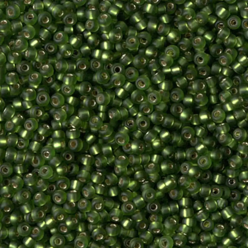 Close-up of green beads with a metallic sheen.