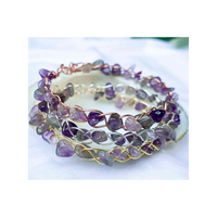 Amethyst gemstone bracelet featuring decorative wire wrapping in silver, gold and copper colours