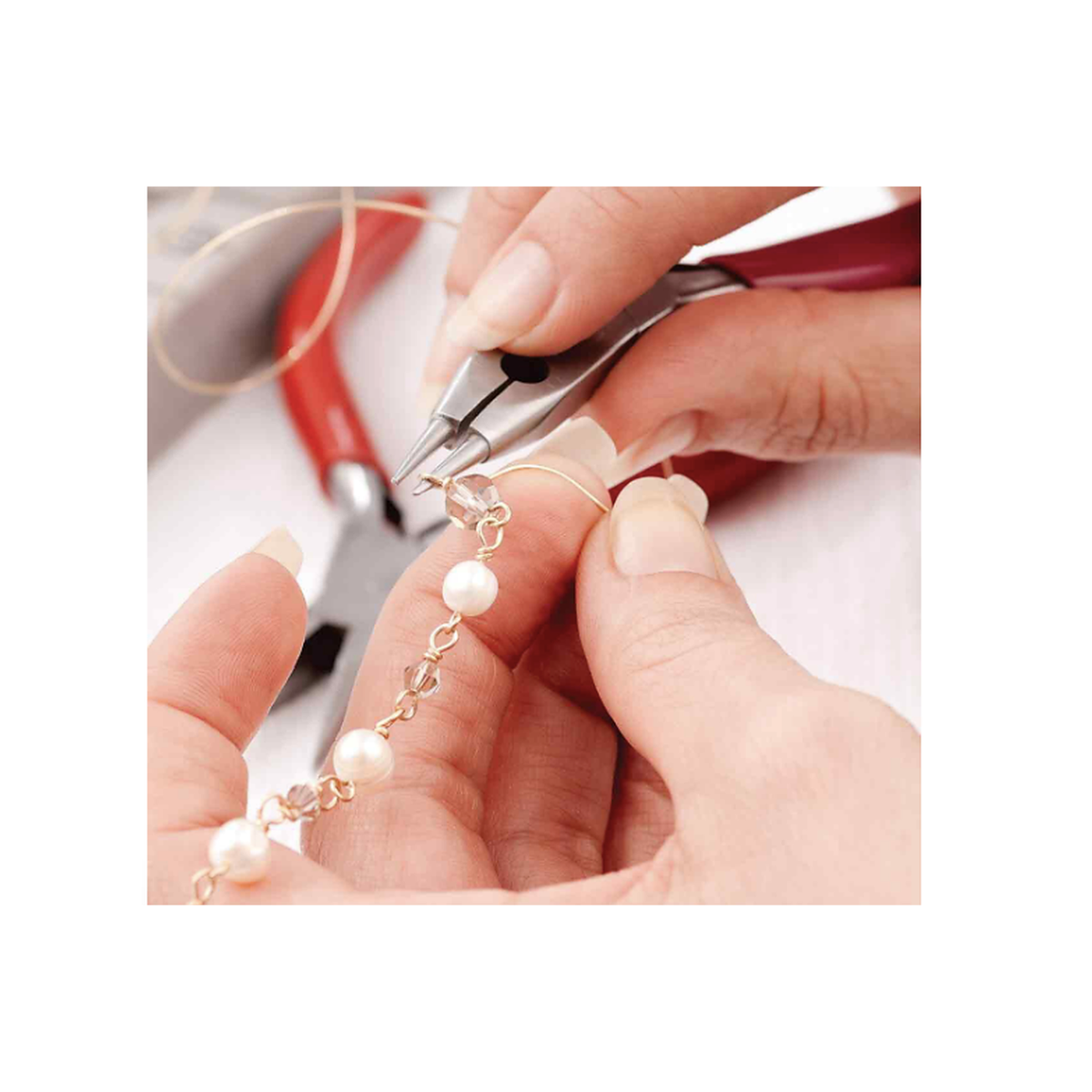 Jewelry maker using pliers to create wire-wrapped jewelry components with beads