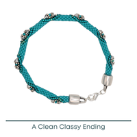 Turquoise beaded bracelet with silver clasp on a white background