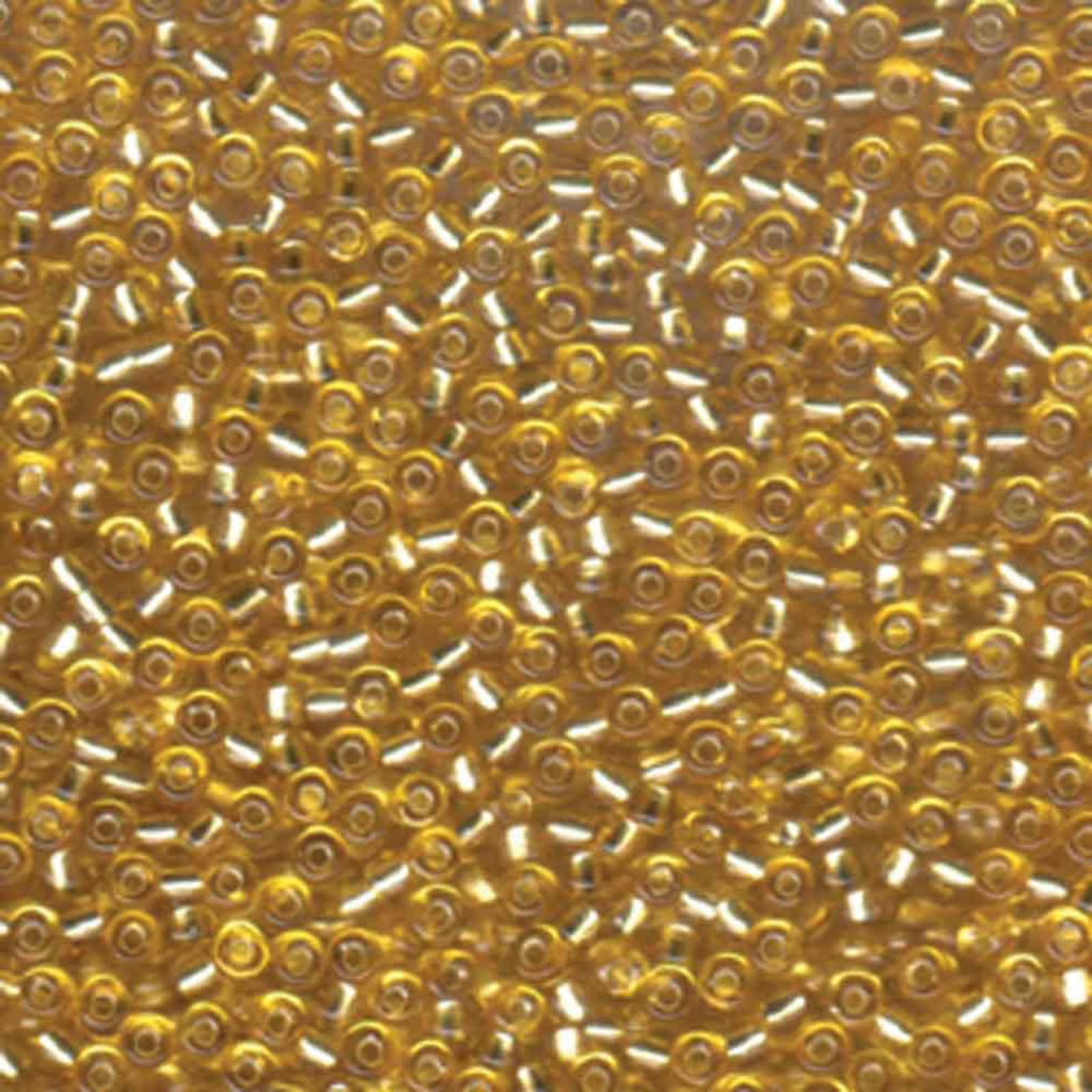 Close-up of gold delica beads with a blurred background