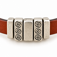 Example of 5mm Crimp Bar Sliders securing decorative sliders on brown flat leather