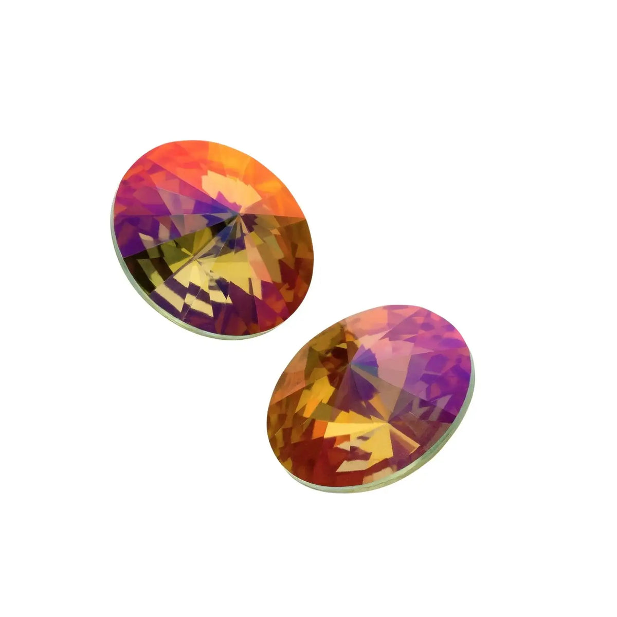 Two round mystic topaz gemstones with orange, purple, and yellow facets isolated on white