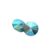 Two round blue olivine shimmer crystal rhinestones with faceted cut on white background