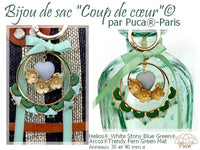 Decorative bag charm with heart and floral design, branded 'Puca Paris'.