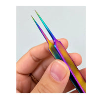 Close-up of Chroma Series rainbow titanium-coated fine point tweezers held in a hand, showing the precision tips and colourful finish
