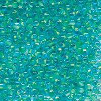 A close-up of many small translucent drop beads in bright aqua, turquoise, and teal tones with reflective highlights.