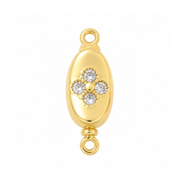 Gold Elara pinch release bayonet peanut clasp with clear cubic zirconia on a white background