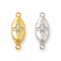 Gold and platinum Elara pinch release bayonet peanut clasps with cubic zirconia on a white background