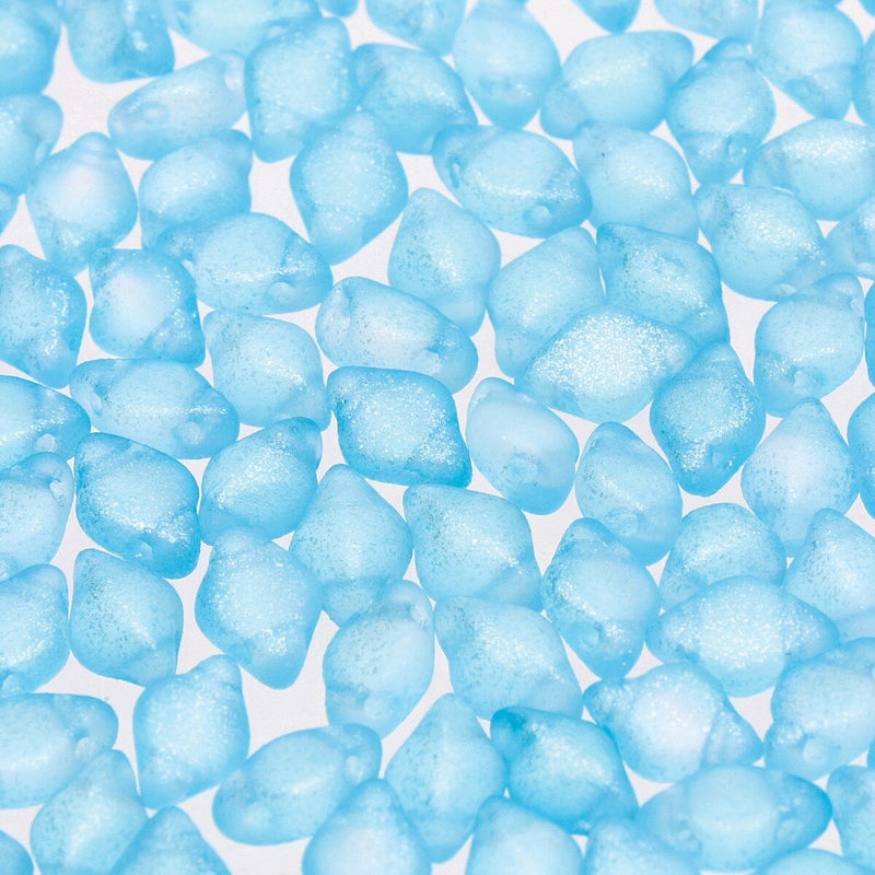 Close-up of blue 2-hole beads on a white background