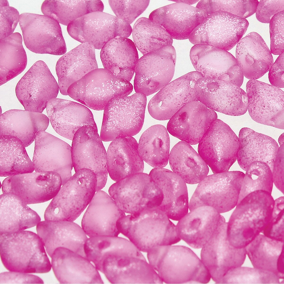 Close-up of pink glittery 2-hole beads on a white background