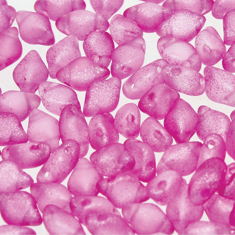 Close-up of pink glittery 2-hole beads on a white background