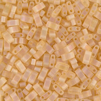 Close-up of matte frosted rectangular beads in pale peach color with two holes