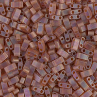 Close-up of translucent purple rectangular two-hole beads scattered in a pile