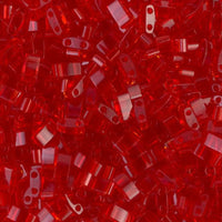 Close-up of shiny red plastic beads with rectangular shapes and two holes, crafting supplies