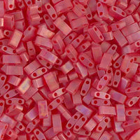 Close-up of numerous small matte red rectangular beads with two holes each