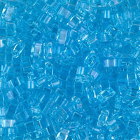 Close-up of small transparent blue plastic beads for crafting and jewelry making