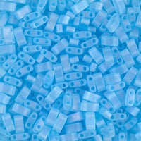 Blue glass 2-hole beads on a blue background