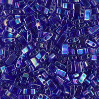 Close-up of shiny blue rectangular glass beads with two holes, used for jewelry making