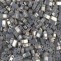 Close-up of metallic double-hole rectangular beads with a glossy gray finish