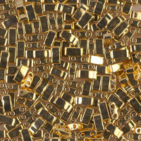 Close-up of shiny gold  jewelry beads with two circular holes