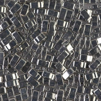 Close-up of shiny metallic rectangular beads with two holes for jewelry making