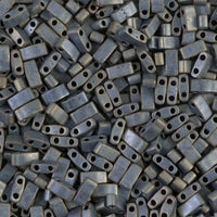 Close-up of matte metallic rectangular beads with two holes, ideal for jewelry making