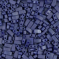 Close-up of multiple rectangular matte navy blue two-holed beads scattered together