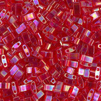 Close-up of shiny red rectangular glass beads with two holes for jewelry making