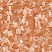 Close-up of small translucent peach-colored plastic beads scattered densely