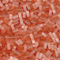 Close-up of opaque and translucent orange plastic chainmail beads for crafting and jewelry