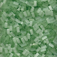 Close-up of transparent light green rectangular plastic beads with two holes for jewelry crafting