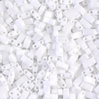 Close-up of white plastic beads with two holes, scattered in a pile for crafting