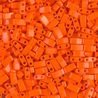 Close-up of scattered orange two-hole plastic beads for crafting and jewelry making