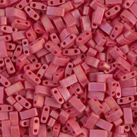 Close-up of small rectangular red plastic beads with two holes, used for jewelry making