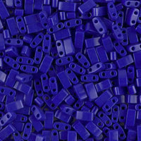 Close-up of numerous dark blue two-hole rectangular beads for jewelry making