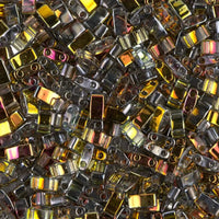 Close-up of shiny metallic rectangular beads in gold, silver, and iridescent colors