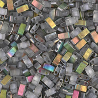 Close-up of rectangular two-hole glass beads in translucent and iridescent colors