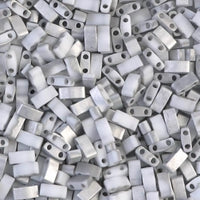 Close-up of silver and white rectangular two-hole beads for jewelry making