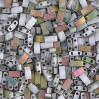 Close-up of rectangular gray and iridescent two-hole beads scattered tightly