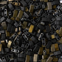 Close-up of small rectangular black and brass two-hole jewelry beads for crafting