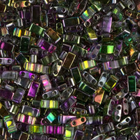 Close-up of iridescent rectangular glass beads with two holes in vibrant purple, green, and yellow shades