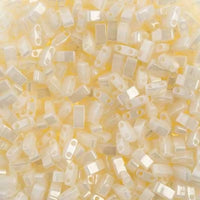 Close-up of translucent pale yellow rectangular beads with two holes, used for jewelry making