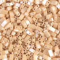 Close-up of glossy beige two-hole rectangular beads for jewelry making