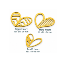 Three gold metal heart-shaped craft charms with different cutout patterns, labeled 'Ziggy Heart', 'Harp Heart', and 'Amalfi Heart' with their dimensions on a white background.
