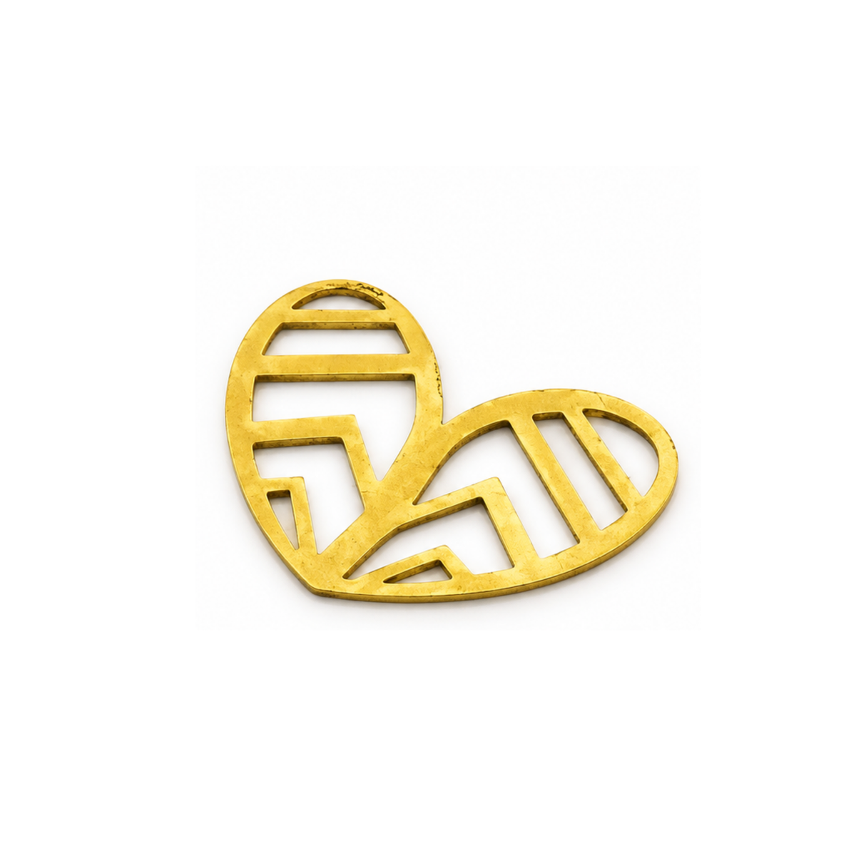 A gold-colored metal heart-shaped brooch with geometric cutout patterns, displayed on a clean white background.