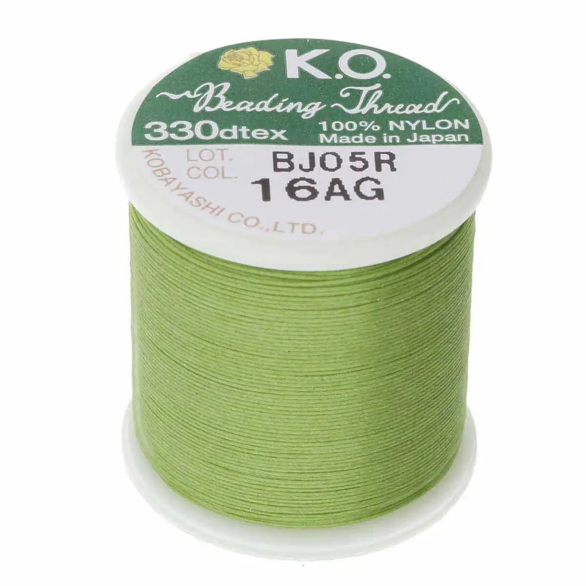 Spool of green K.O. beading thread on a white background