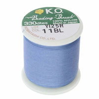 Spool of K.O. beading thread on a white background